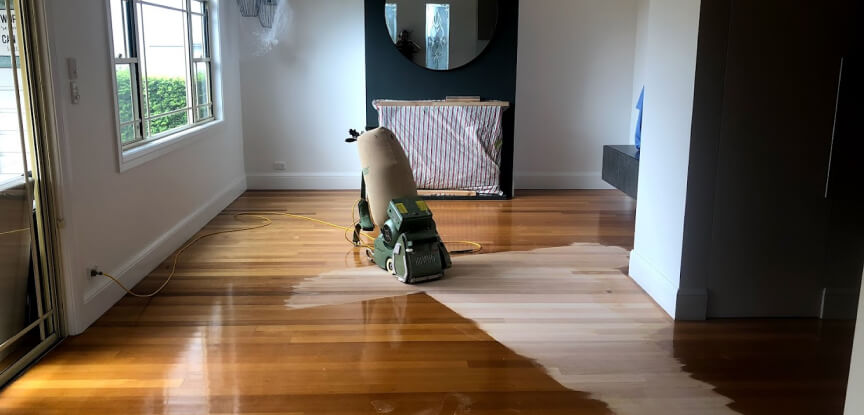 A work in progress wooden floor revealing the finished part and the machine or tool used with a mirror and window view